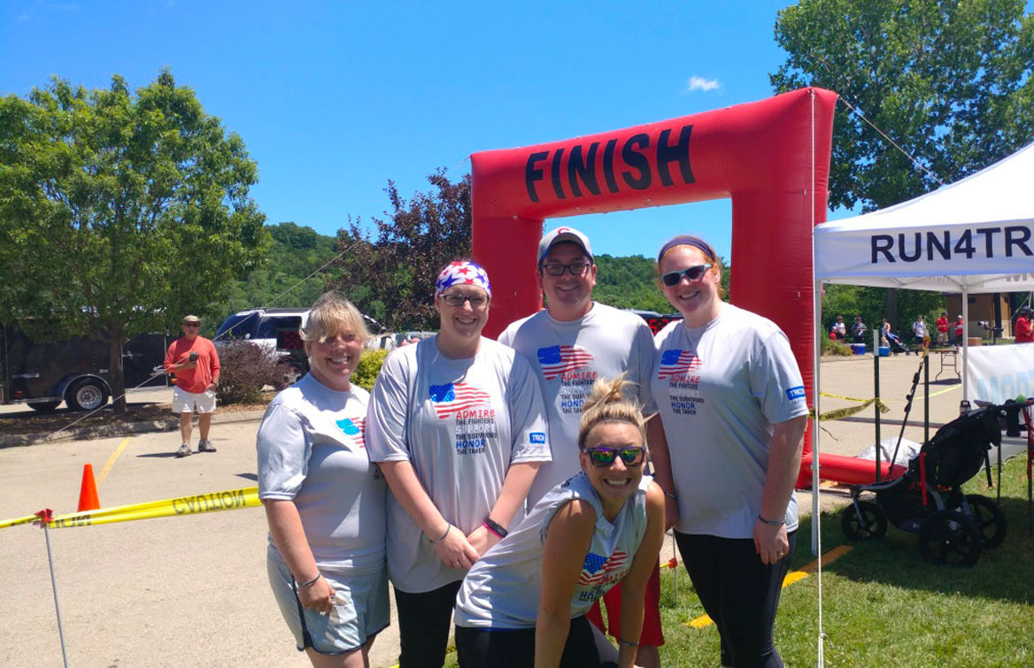 Several TRICOR employees at the finish line of a local 5K race