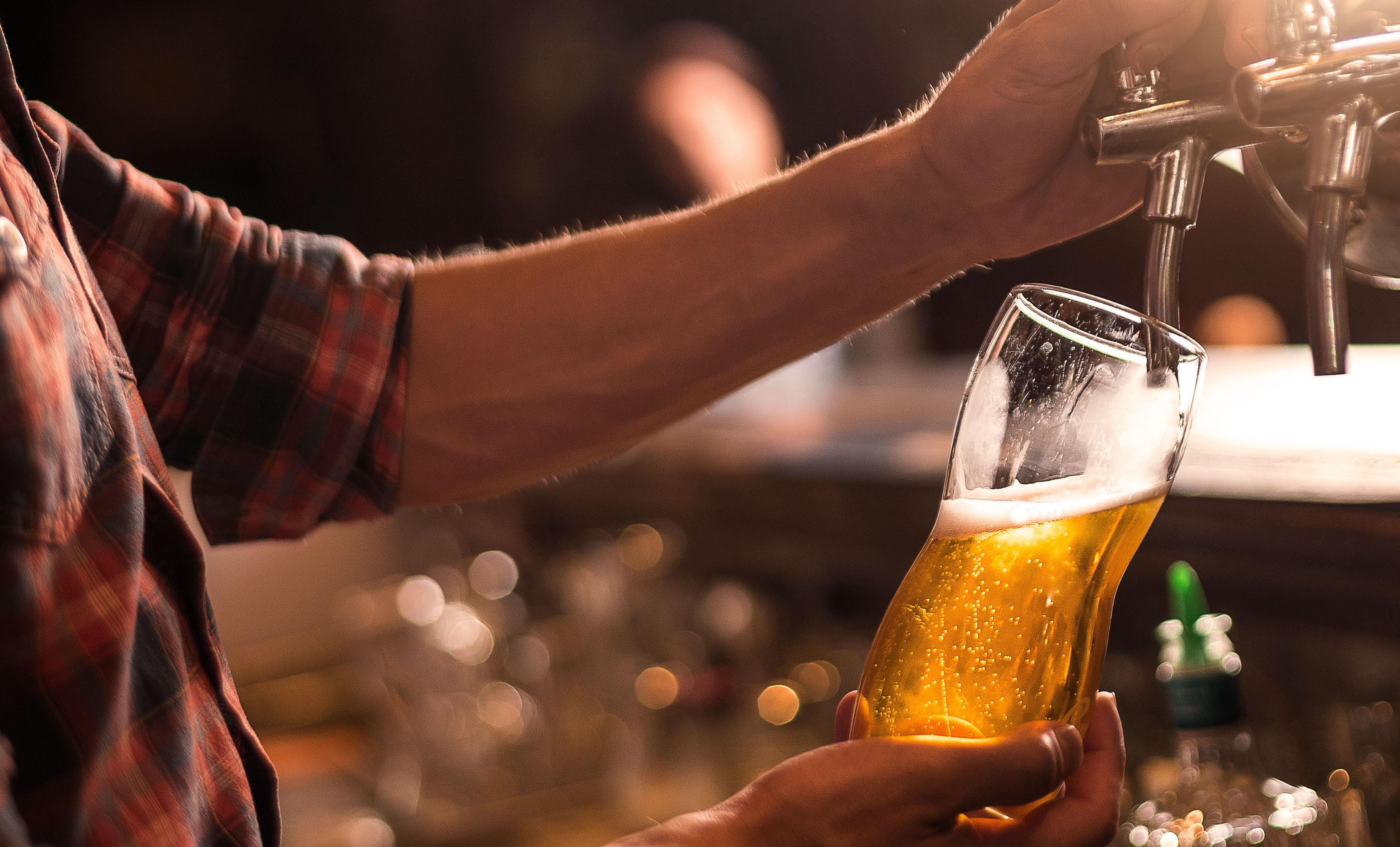 A man pouring a tap beer