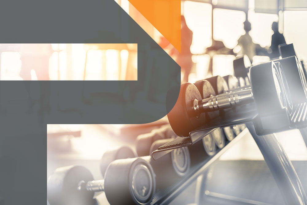 Man working out by carring a heavy piece of gym equipment on his shoulder &mdash; fitness marketing brochure