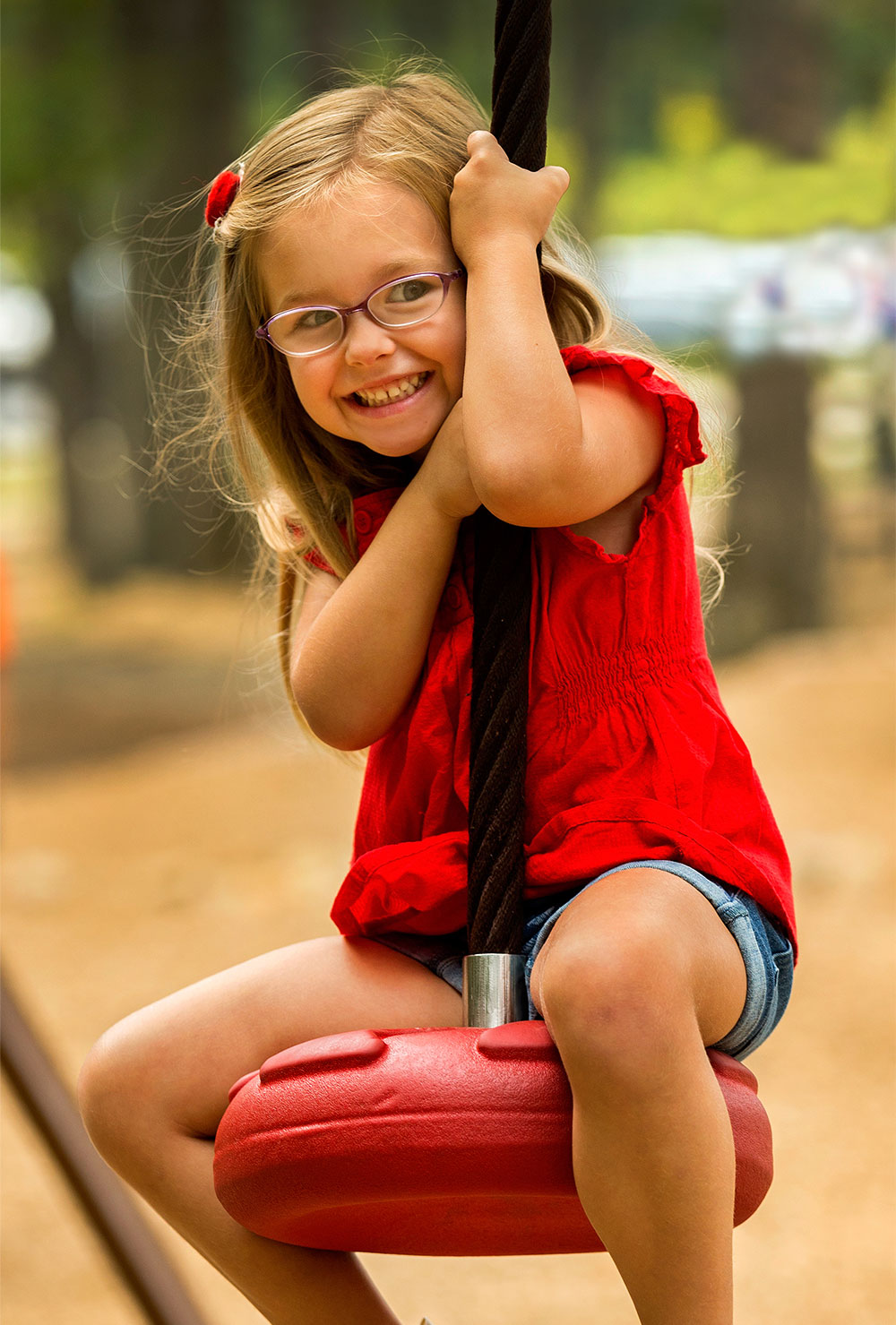 young, smiling girl at a playground &mdash; fitness marketing work