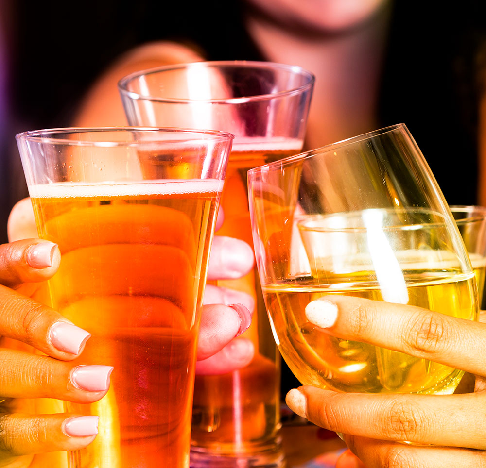 Several glasses of alcohol being raised for a toast &mdash; tourism brand marketing