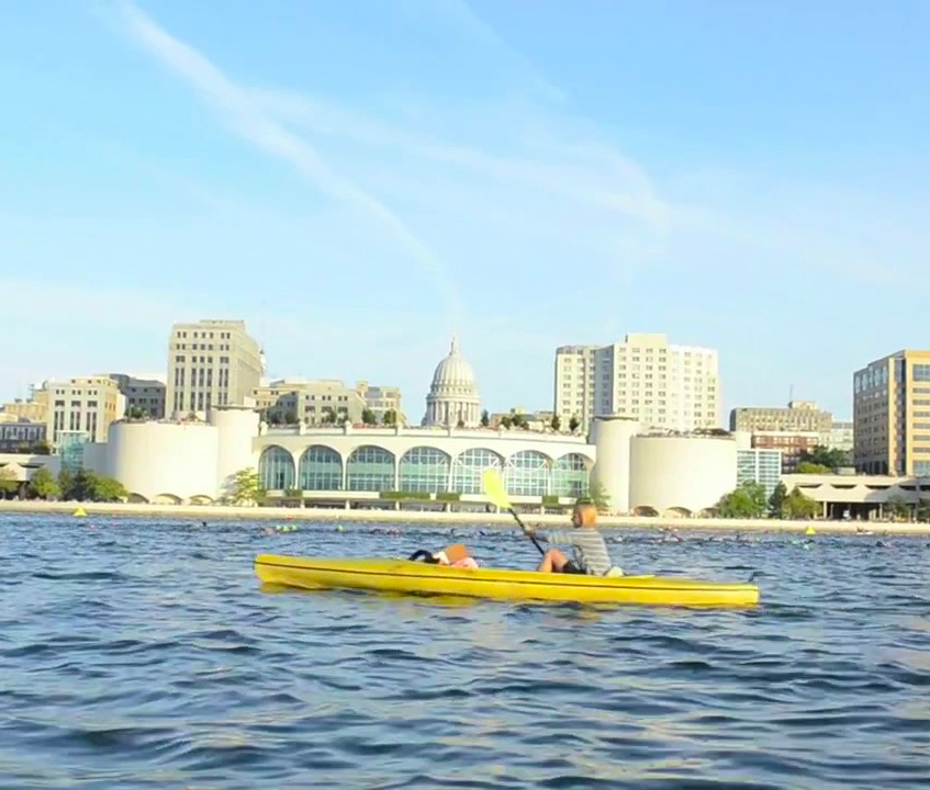 Woman rowing on Lake Monona in Madison, Wisconsin, with the state capitol in the background &mdash; video marketing